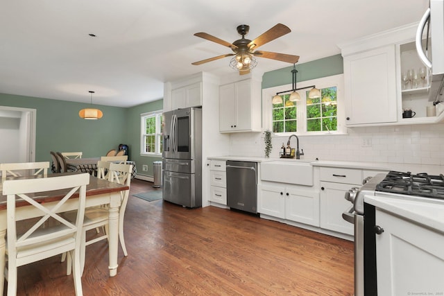 kitchen featuring appliances with stainless steel finishes, a sink, ceiling fan, and white cabinetry