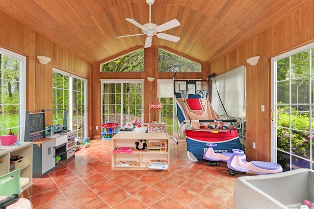 sunroom / solarium with lofted ceiling, tile patterned floors, wooden walls, and wooden ceiling