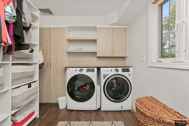 laundry area featuring washing machine and dryer and dark wood finished floors