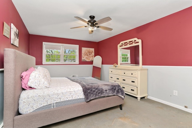 bedroom featuring multiple windows, carpet floors, baseboards, and ceiling fan