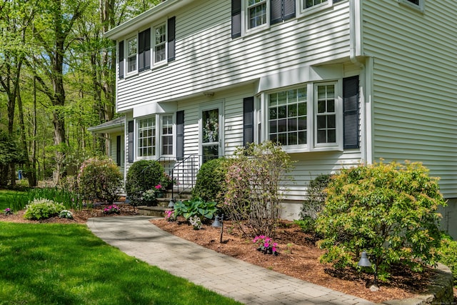 view of exterior entry featuring a yard