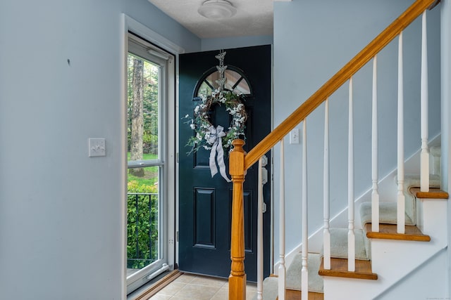 tiled foyer with stairs