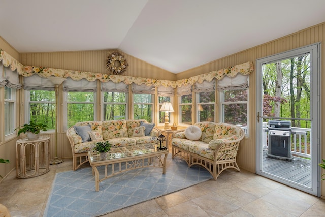 sunroom with vaulted ceiling and stone finish floors