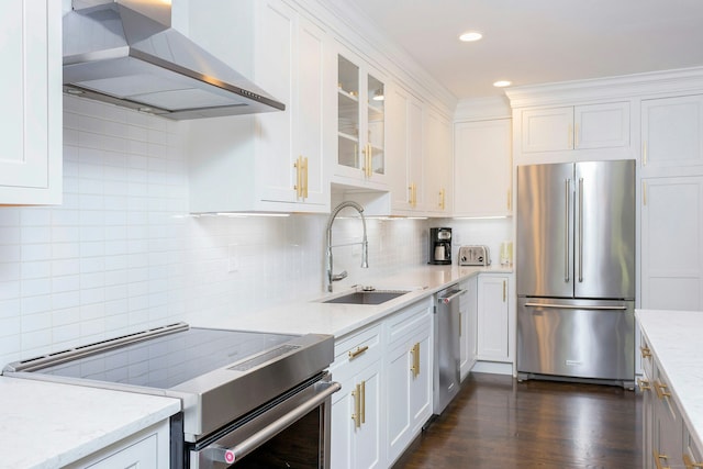 38 Heritage Hill Rd Unit 38, New Canaan, CT 06840 - kitchen featuring appliances with stainless steel finishes, range hood, a sink, white cabinets, and recessed lighting