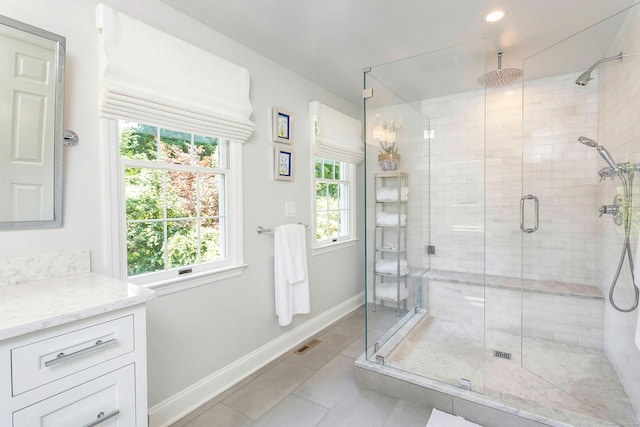 38 Heritage Hill Rd Unit 38, New Canaan, CT 06840 - bathroom with baseboards, healthy amount of natural light, a stall shower, tile patterned floors, and recessed lighting