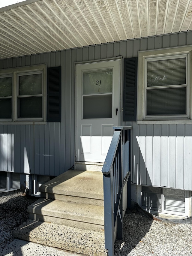 property entrance featuring board and batten siding