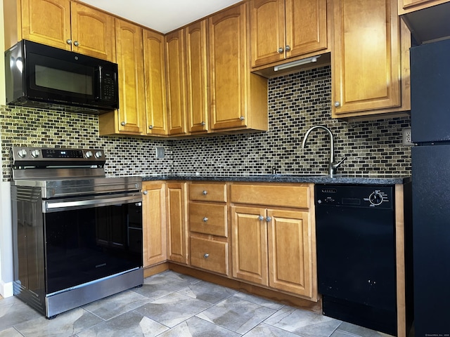 kitchen with black appliances, backsplash, and a sink