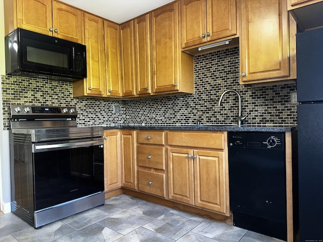 kitchen with black appliances, tasteful backsplash, and brown cabinetry