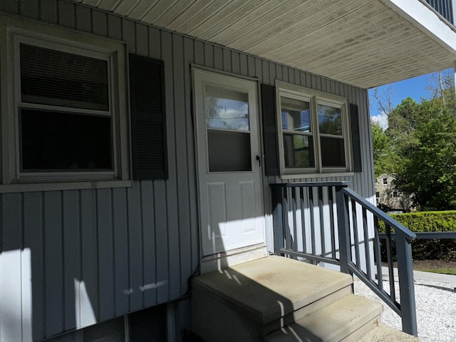 property entrance featuring board and batten siding