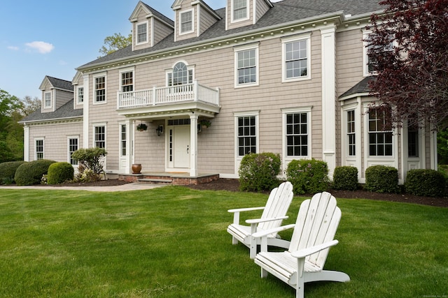 61 Governors Way, Madison, CT 06443 - colonial-style house featuring a balcony, a front yard, and a shingled roof