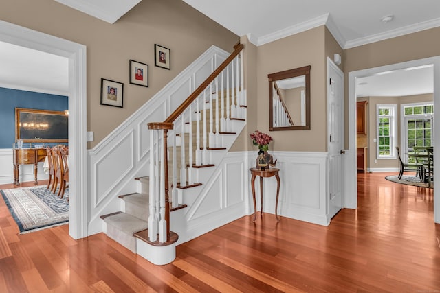 61 Governors Way, Madison, CT 06443 - staircase featuring wood finished floors, wainscoting, a decorative wall, and ornamental molding