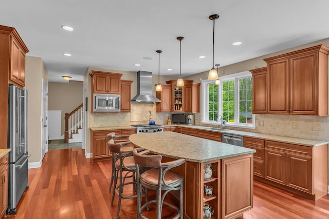 61 Governors Way, Madison, CT 06443 - kitchen featuring wall chimney range hood, stainless steel appliances, brown cabinets, light wood-style floors, and recessed lighting