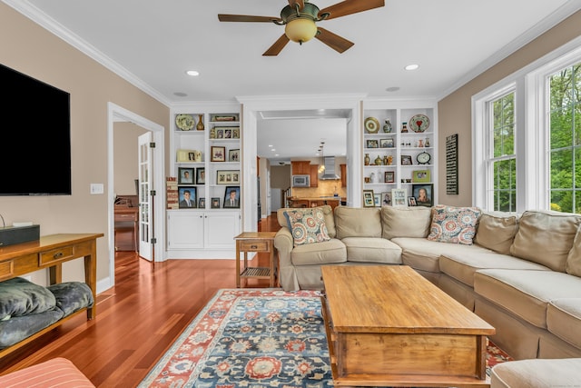 61 Governors Way, Madison, CT 06443 - living area with a ceiling fan, wood finished floors, ornamental molding, built in shelves, and recessed lighting