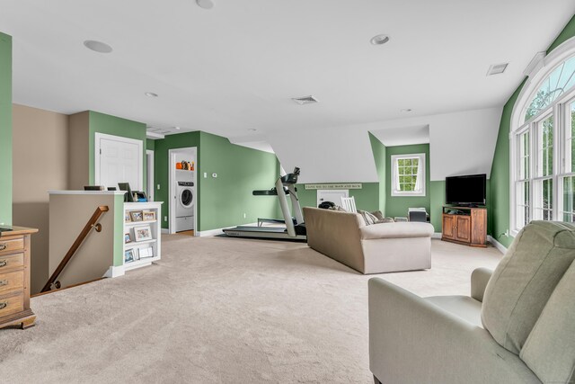 61 Governors Way, Madison, CT 06443 - living area featuring washer / dryer, light colored carpet, plenty of natural light, and baseboards