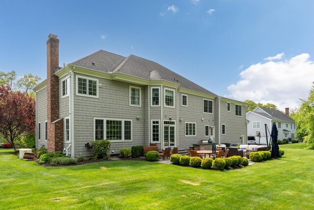 61 Governors Way, Madison, CT 06443 - rear view of property featuring an outdoor hangout area, a patio, a lawn, a chimney, and entry steps