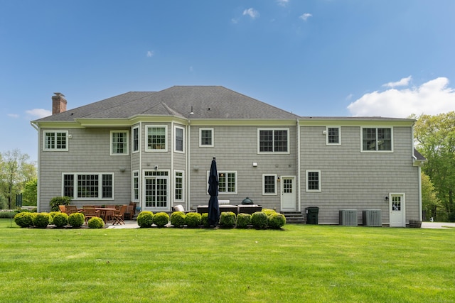 61 Governors Way, Madison, CT 06443 - back of house featuring a chimney, a lawn, entry steps, and central air condition unit