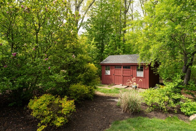 61 Governors Way, Madison, CT 06443 - view of yard with a storage unit, an outbuilding, and a forest view