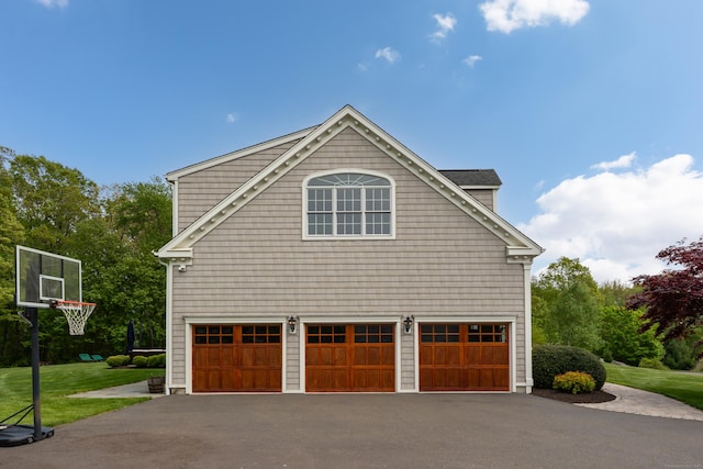 61 Governors Way, Madison, CT 06443 - view of side of home featuring driveway, an attached garage, and a yard