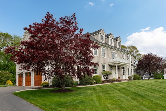 61 Governors Way, Madison, CT 06443 - colonial home with a front lawn, a balcony, and asphalt driveway