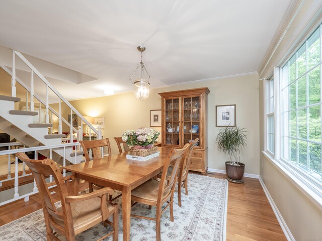 120 Prospect St Apt 2, Ridgefield, CT 06877 - dining space with healthy amount of natural light, stairway, light wood-style floors, and crown molding