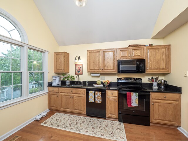 120 Prospect St Apt 2, Ridgefield, CT 06877 - kitchen featuring black appliances, dark countertops, light wood-style flooring, and high vaulted ceiling