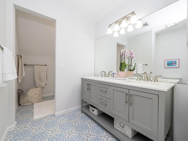 120 Prospect St Apt 2, Ridgefield, CT 06877 - bathroom featuring double vanity and baseboards