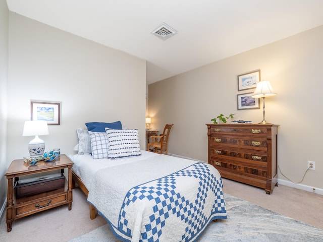 bedroom featuring carpet and baseboards