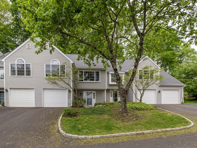 120 Prospect St Apt 2, Ridgefield, CT 06877 - view of front of house featuring driveway, a garage, roof with shingles, and a front lawn