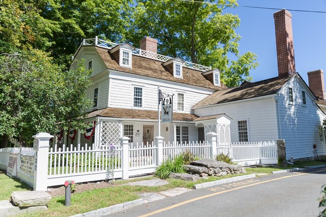 120 Prospect St Apt 2, Ridgefield, CT 06877 - view of front of house with a chimney and a fenced front yard
