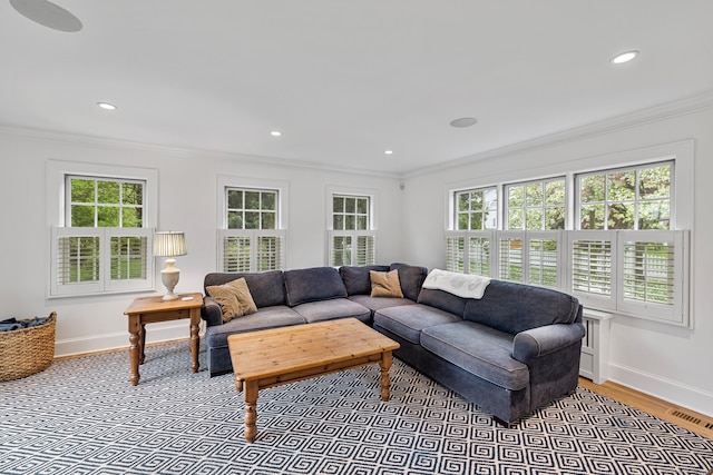 living room featuring ornamental molding, healthy amount of natural light, baseboards, recessed lighting, and light wood-style flooring