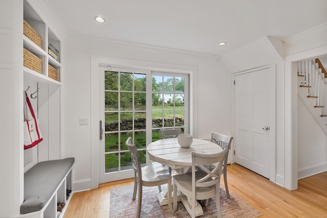 dining space with stairs, light wood-type flooring, recessed lighting, ornamental molding, and baseboards
