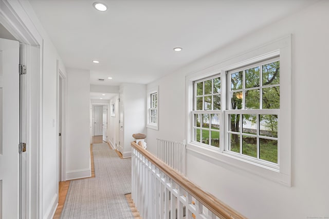 hall featuring recessed lighting and baseboards