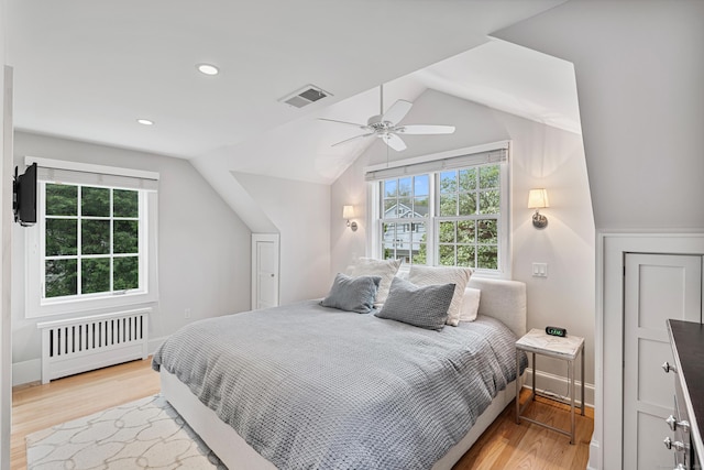 bedroom with radiator, light wood-type flooring, lofted ceiling, ceiling fan, and recessed lighting