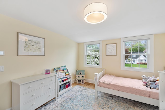 bedroom featuring light wood-style flooring and baseboards