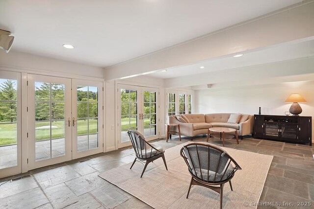 2 Aspetuck Hill Ln, Weston, CT 06883 - living area with french doors, stone tile flooring, plenty of natural light, and recessed lighting