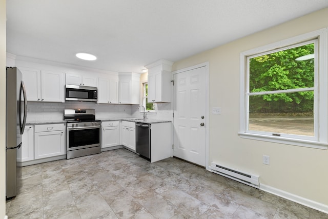 63 Summit St Apt 16, Manchester, CT 06040 - kitchen featuring stainless steel appliances, a baseboard heating unit, backsplash, white cabinets, and light stone countertops