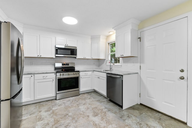 63 Summit St Apt 16, Manchester, CT 06040 - kitchen featuring stainless steel appliances, decorative backsplash, white cabinets, a sink, and light stone counters