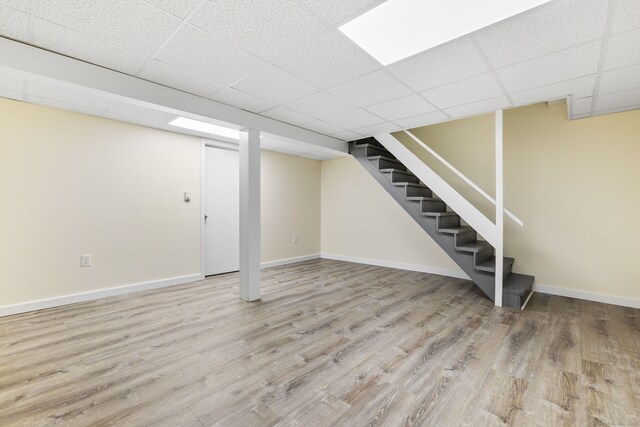63 Summit St Apt 16, Manchester, CT 06040 - finished below grade area featuring a paneled ceiling, stairway, baseboards, and wood finished floors