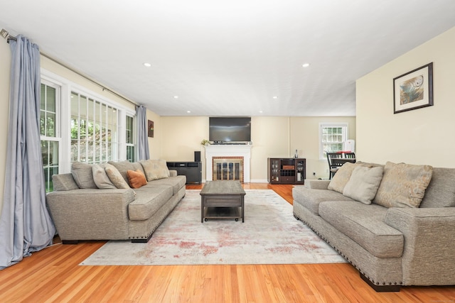 108 Fox Den Rd, Bristol, CT 06010 - living area featuring wood finished floors, a brick fireplace, and recessed lighting