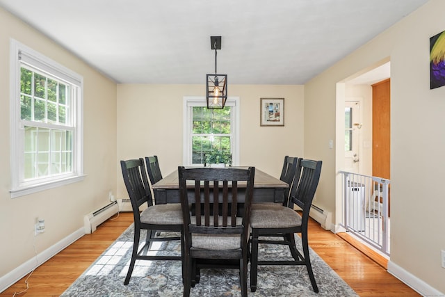 108 Fox Den Rd, Bristol, CT 06010 - dining area with baseboard heating, light wood-type flooring, and baseboards