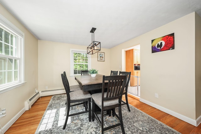 108 Fox Den Rd, Bristol, CT 06010 - dining area featuring light wood-style flooring, baseboards, and a chandelier