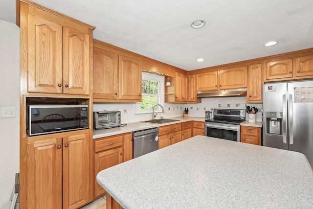 108 Fox Den Rd, Bristol, CT 06010 - kitchen with appliances with stainless steel finishes, a sink, under cabinet range hood, light countertops, and recessed lighting