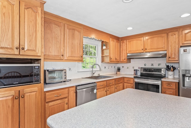 108 Fox Den Rd, Bristol, CT 06010 - kitchen with stainless steel appliances, under cabinet range hood, a sink, light countertops, and backsplash