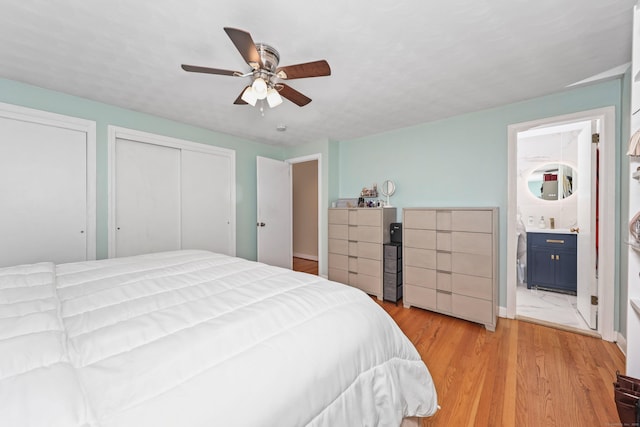 108 Fox Den Rd, Bristol, CT 06010 - bedroom featuring two closets, light wood-style floors, a ceiling fan, and ensuite bathroom