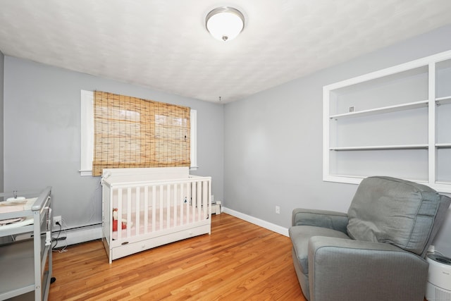 108 Fox Den Rd, Bristol, CT 06010 - bedroom with light wood finished floors, baseboards, and baseboard heating