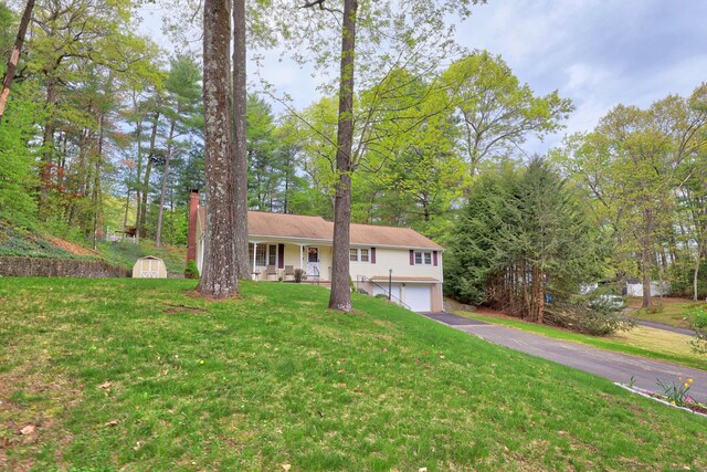 108 Fox Den Rd, Bristol, CT 06010 - ranch-style house with a porch, a shed, asphalt driveway, an attached garage, and a front yard