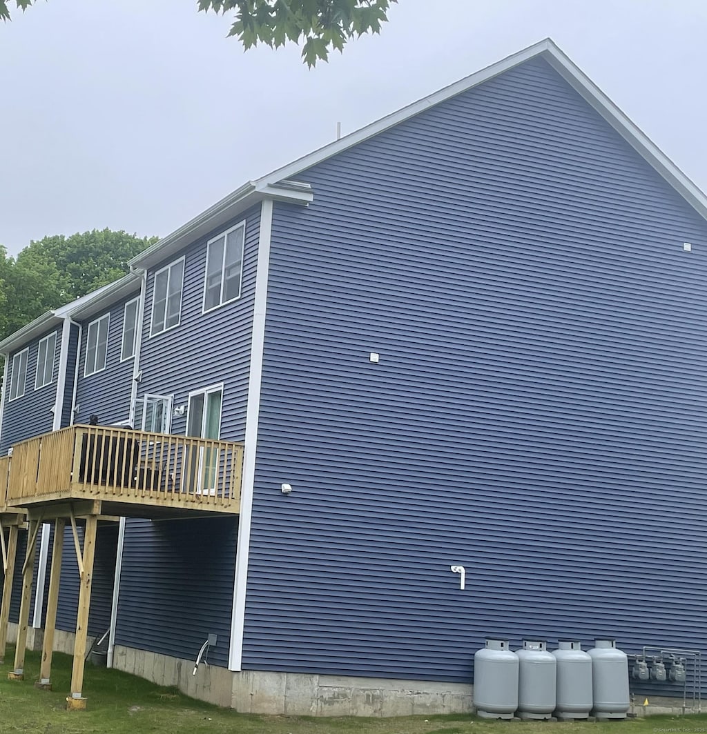 view of side of property with a wooden deck