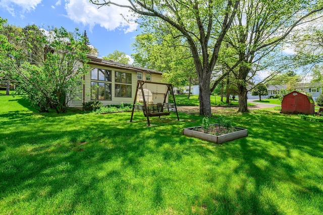 view of grassy yard with a shed and an outdoor structure