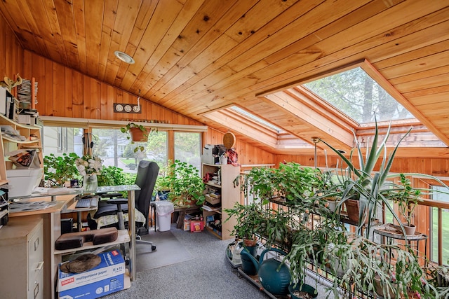 office area with vaulted ceiling, a skylight, wood walls, carpet, and wood ceiling