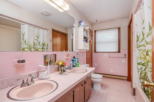 full bath featuring a baseboard radiator, tile walls, toilet, double vanity, and tile patterned flooring